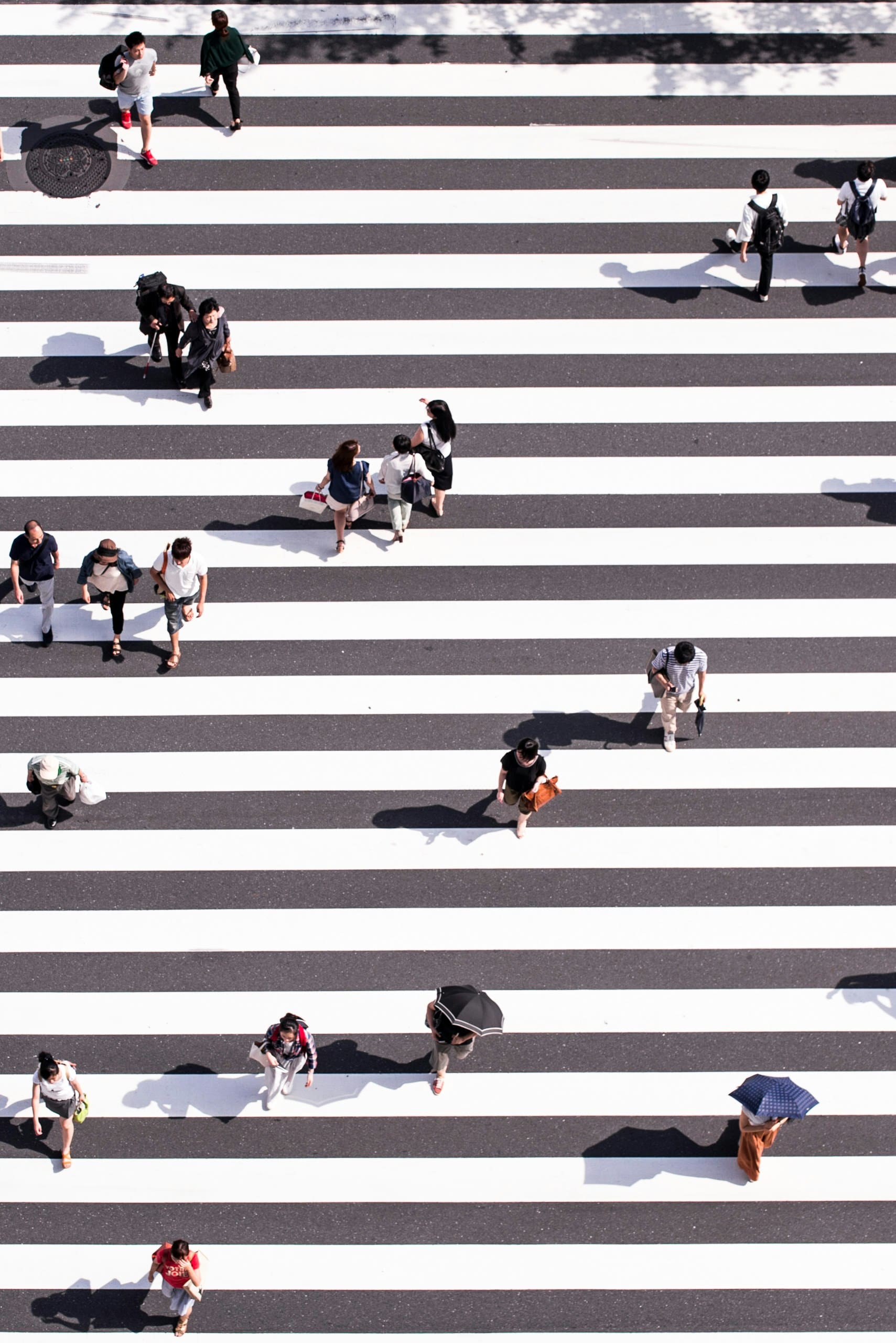 People walking across a zebra crossing in different directions, visually representing diverse audience segments. This image illustrates the importance of understanding and targeting distinct groups for better marketing results. #audiencesegmentation #targetaudience #marketingstrategy